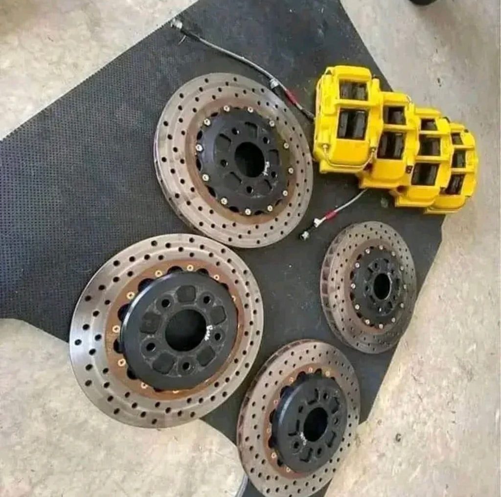 Performance AFX 2-piece rotors and yellow OEM calipers with stainless steel brake lines.