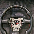 C6 carbon fiber steering wheel with Alcantara airbag cover.